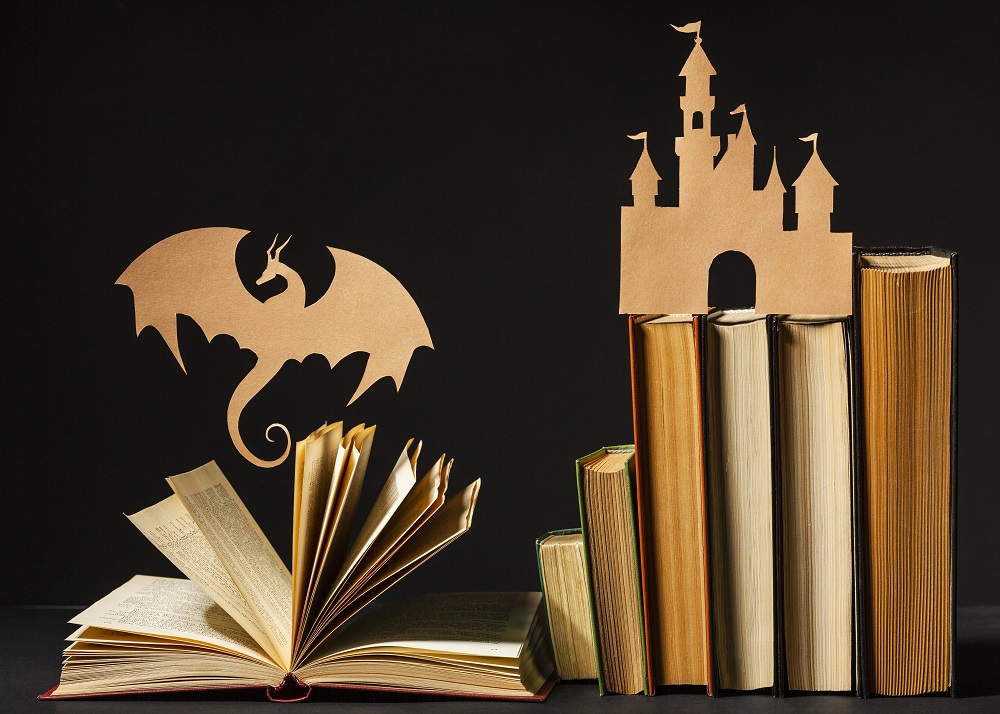Qué es el storytelling: Libros y siluetas de castillo y dragón.